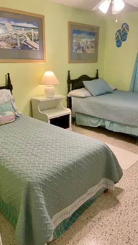 a bedroom with two beds and painting on the wall