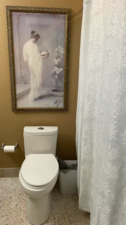 a white toilet sitting next to a small bathroom