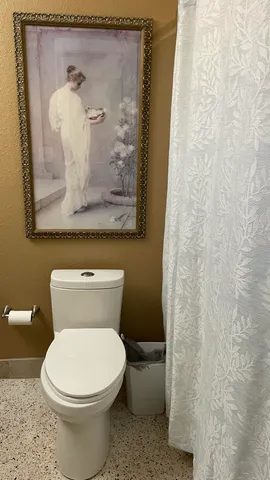 a white toilet sitting next to a small bathroom
