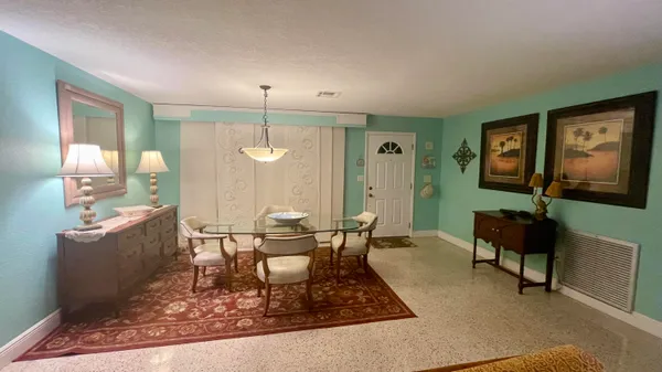a living room with furniture a lamp and a dining table