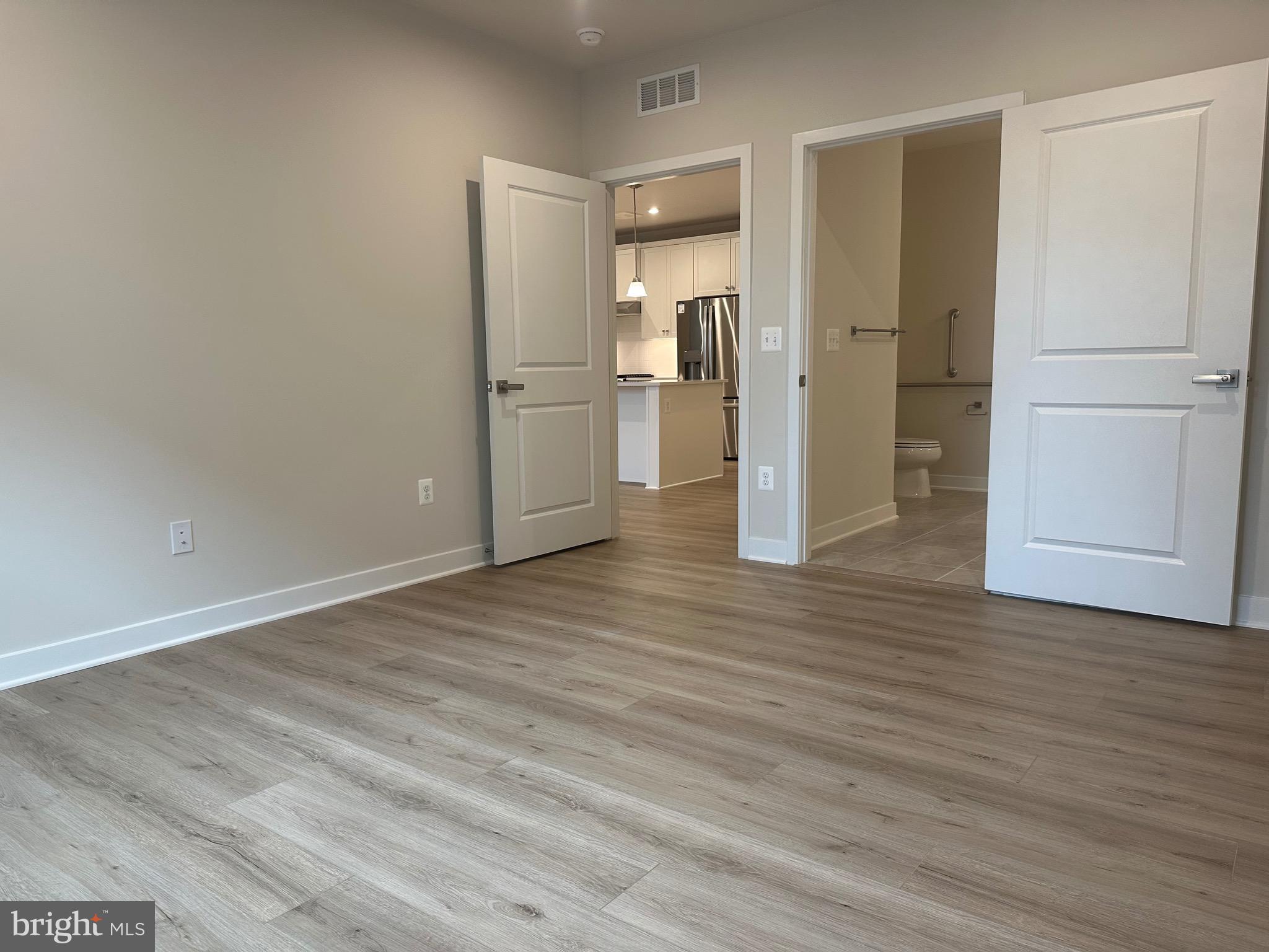 14401 Milk Thistle Lane, Unit 335 Chantilly, VA 20151 - Photo 13 of 17 a view of a kitchen with a refrigerator and wooden floor