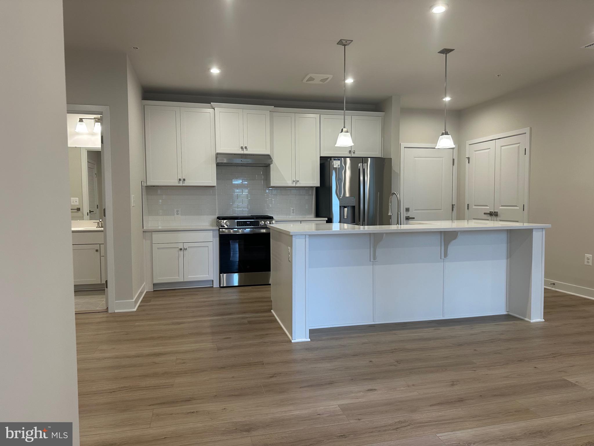 14401 Milk Thistle Lane, Unit 335 Chantilly, VA 20151 - Photo 2 of 17 a large kitchen with stainless steel appliances granite countertop a sink and cabinets