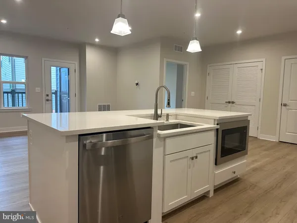 a kitchen with a sink and a refrigerator