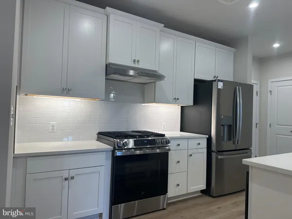 a kitchen with a stove and a refrigerator