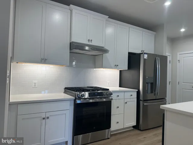 a kitchen with a stove and a refrigerator