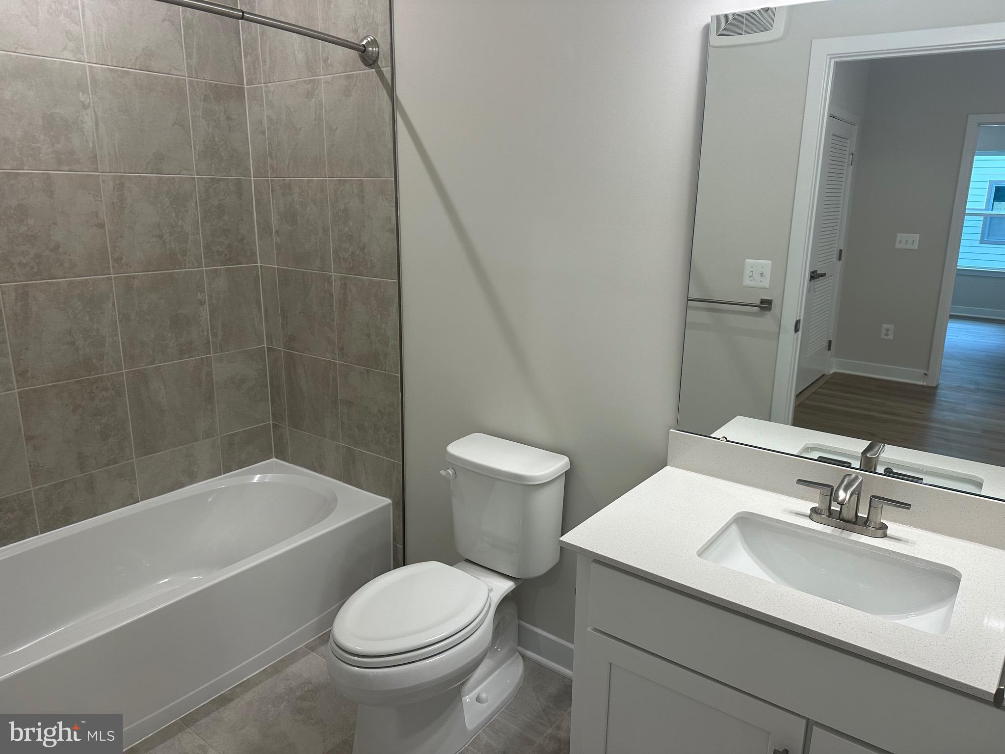 14401 Milk Thistle Lane, Unit 335 Chantilly, VA 20151 - Photo 6 of 17 a bathroom with a sink toilet and shower