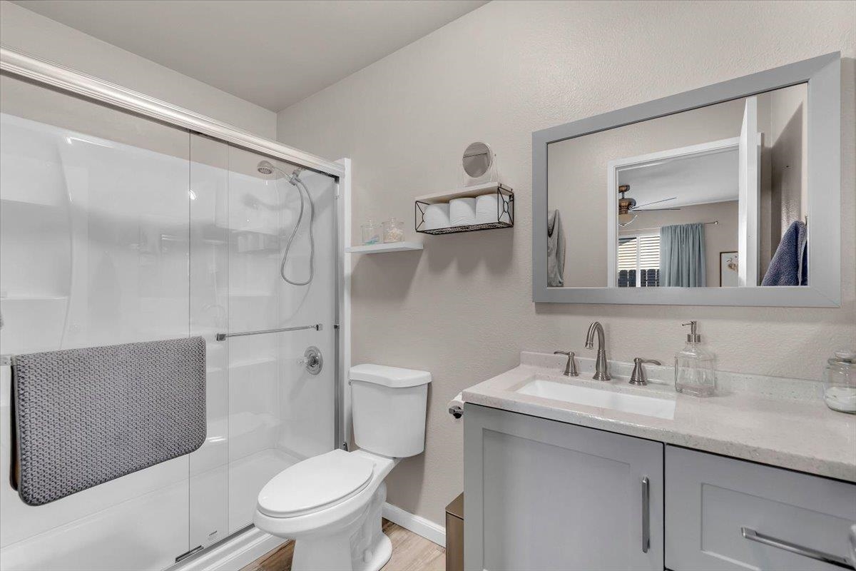 2110 Gentry Way Red Bluff, CA 96080 - Photo 19 of 47 a bathroom with a granite countertop toilet sink and a mirror