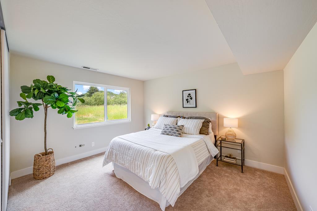 1695 Seascape Boulevard Aptos, CA 95003 - Photo 20 of 87 a bedroom with a bed and a potted plant