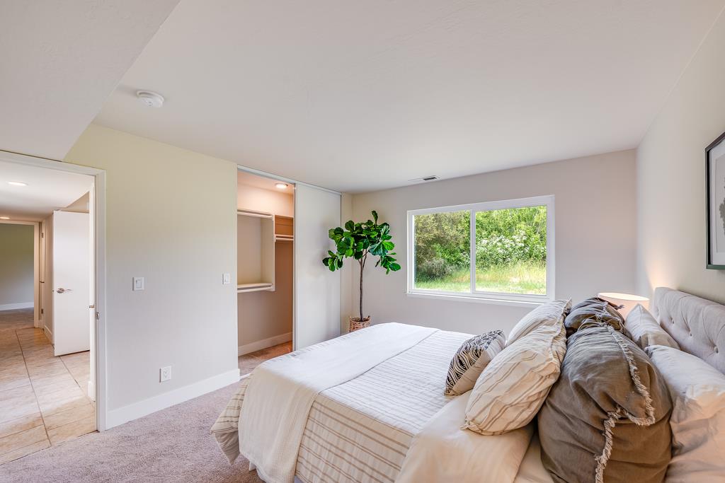 1695 Seascape Boulevard Aptos, CA 95003 - Photo 21 of 87 a bed sitting in a bedroom next to a window and a larger closet