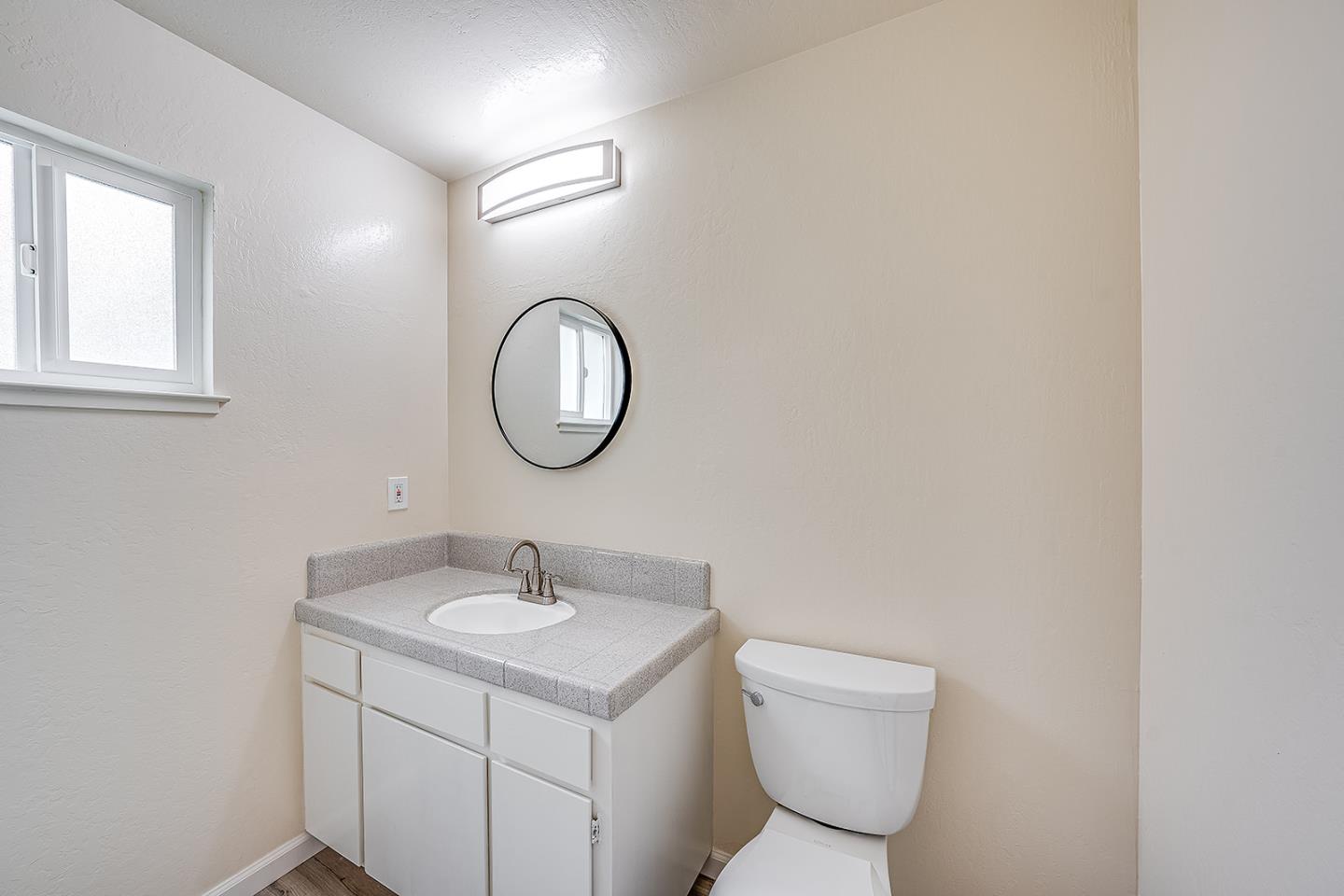 1695 Seascape Boulevard Aptos, CA 95003 - Photo 44 of 87 a bathroom with a toilet a sink and a mirror