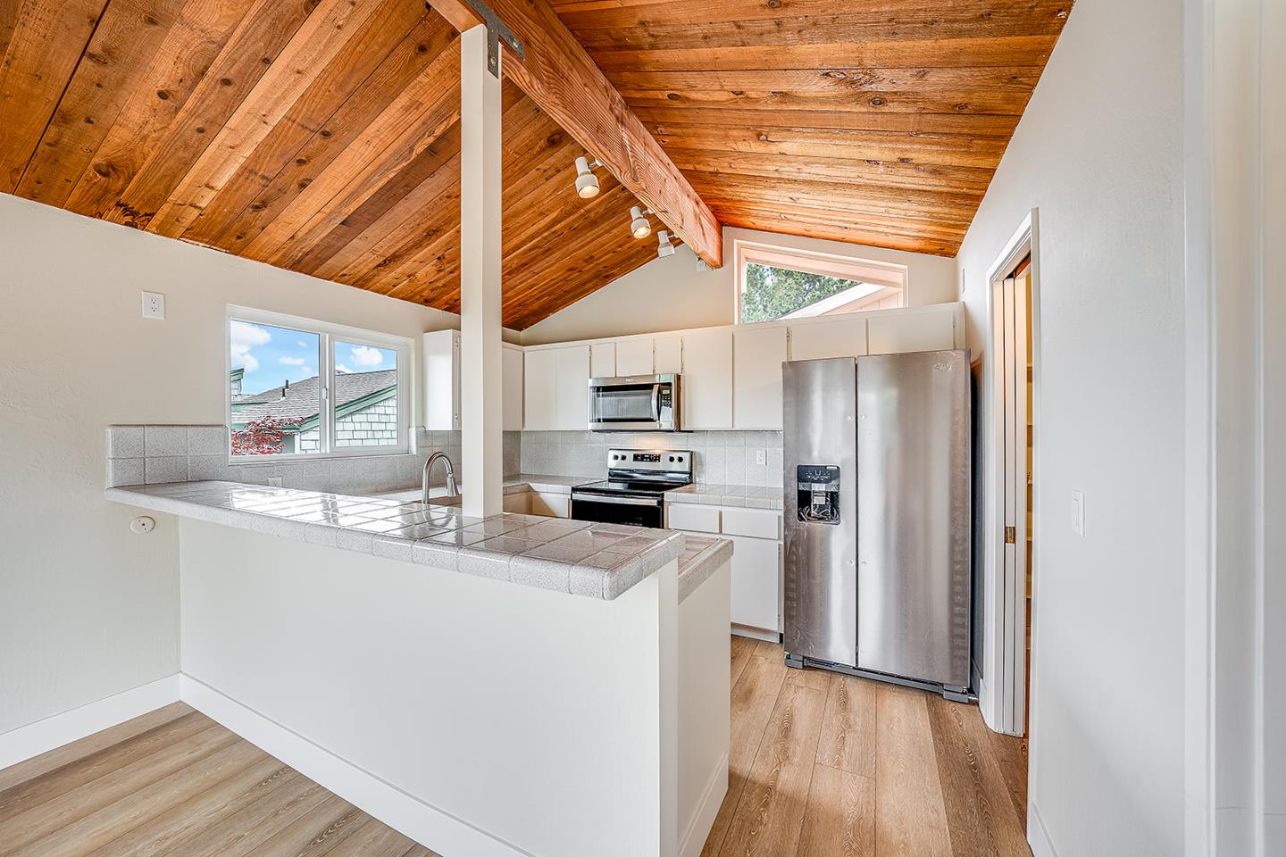 1695 Seascape Boulevard Aptos, CA 95003 - Photo 60 of 87 a kitchen with stainless steel appliances granite countertop a refrigerator a sink and wooden floors