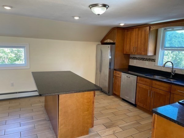 272-2 Nevada Street, Unit 2 Newton, MA 02460 - Photo 3 of 28 a kitchen with a sink a refrigerator and wooden cabinets