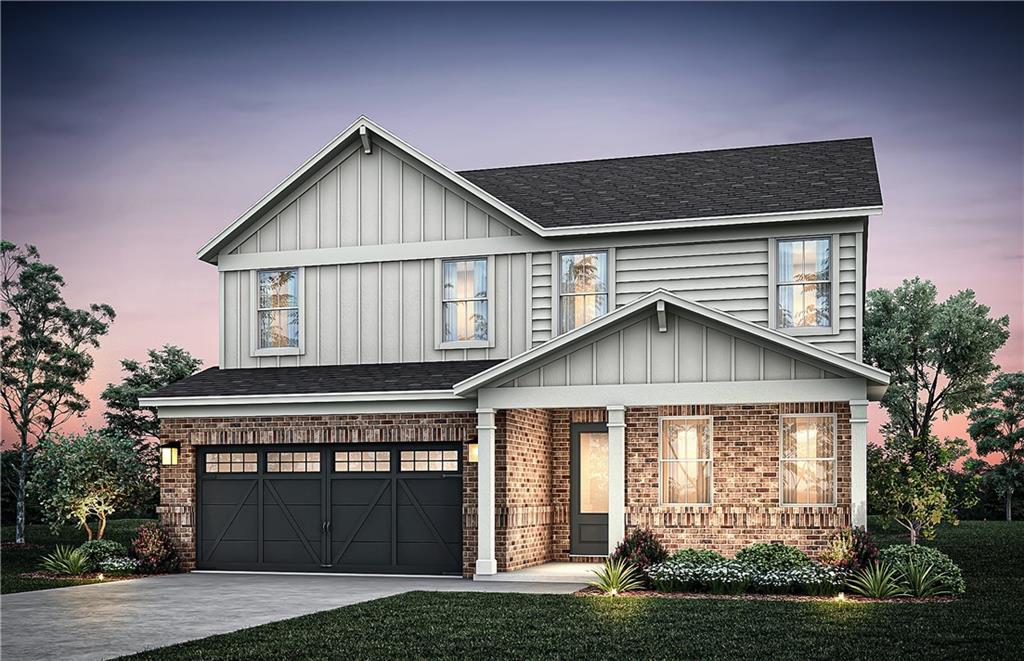 a front view of a house with a garden and yard