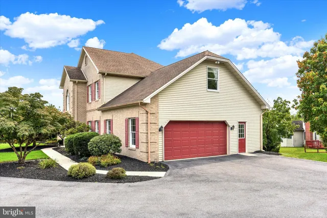 a view of backyard of house and garage