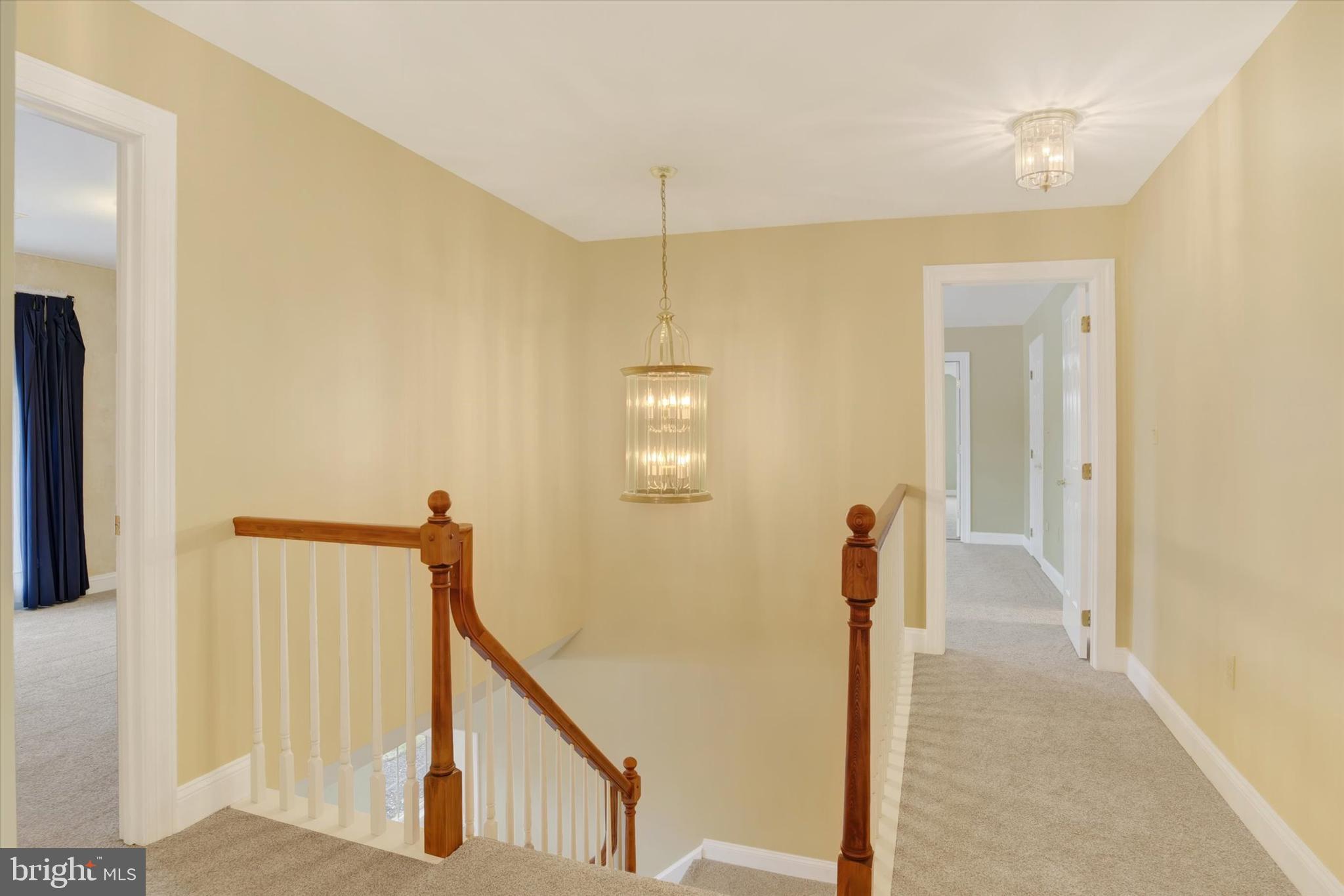 4420 Rathlin Court Harrisburg, PA 17112 - Photo 22 of 41 a view of a hallway with wooden floor and stairs