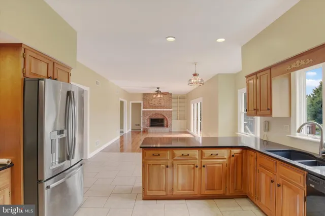 a kitchen with stainless steel appliances granite countertop a refrigerator and a sink