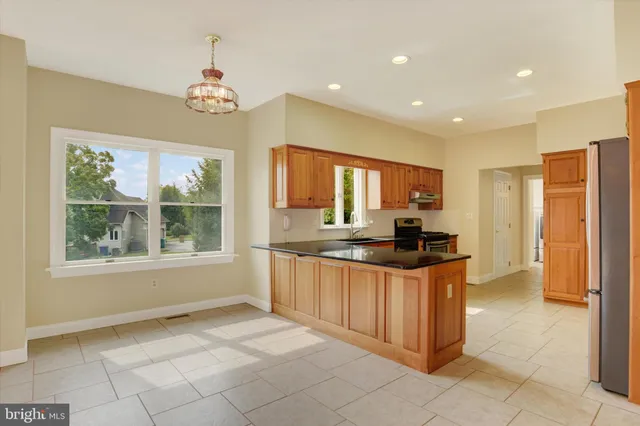 a kitchen with stainless steel appliances granite countertop a stove and a sink