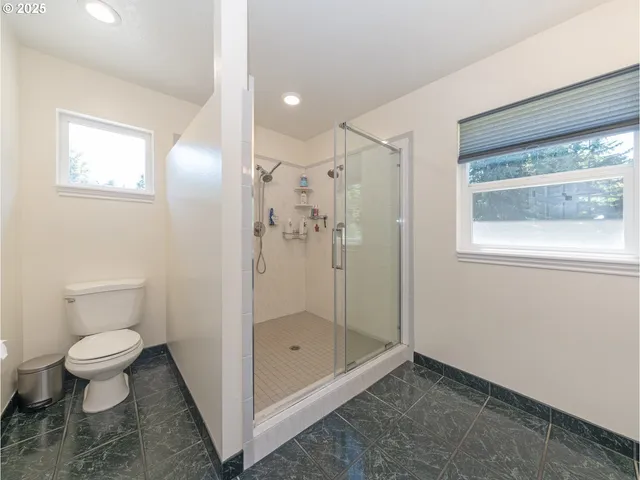 a room with pool table and windows