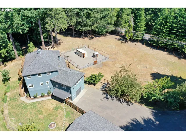 an aerial view of a house with a yard basket ball court
