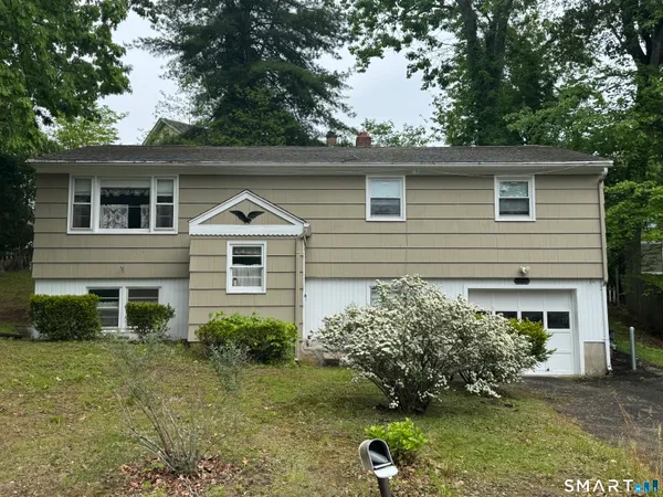 a view of a house with a yard and plants