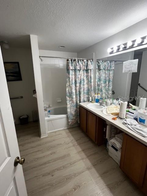 3010 Greynolds Avenue Spring Hill, FL 34608 - Photo 3 of 11 a bathroom with a double vanity sink a mirror and a bathtub