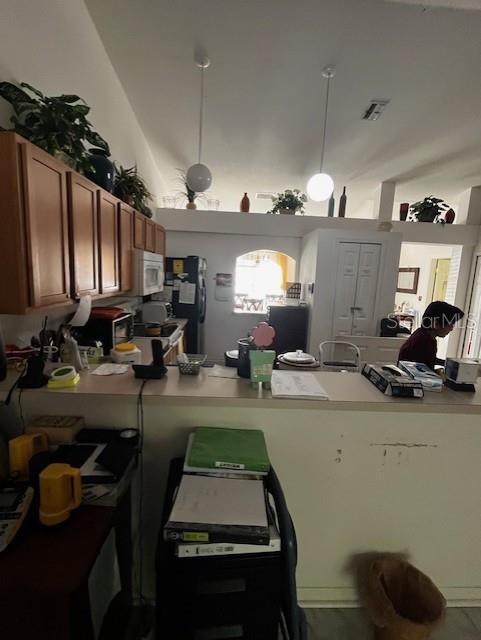 3010 Greynolds Avenue Spring Hill, FL 34608 - Photo 8 of 11 a kitchen with sink refrigerator and microwave