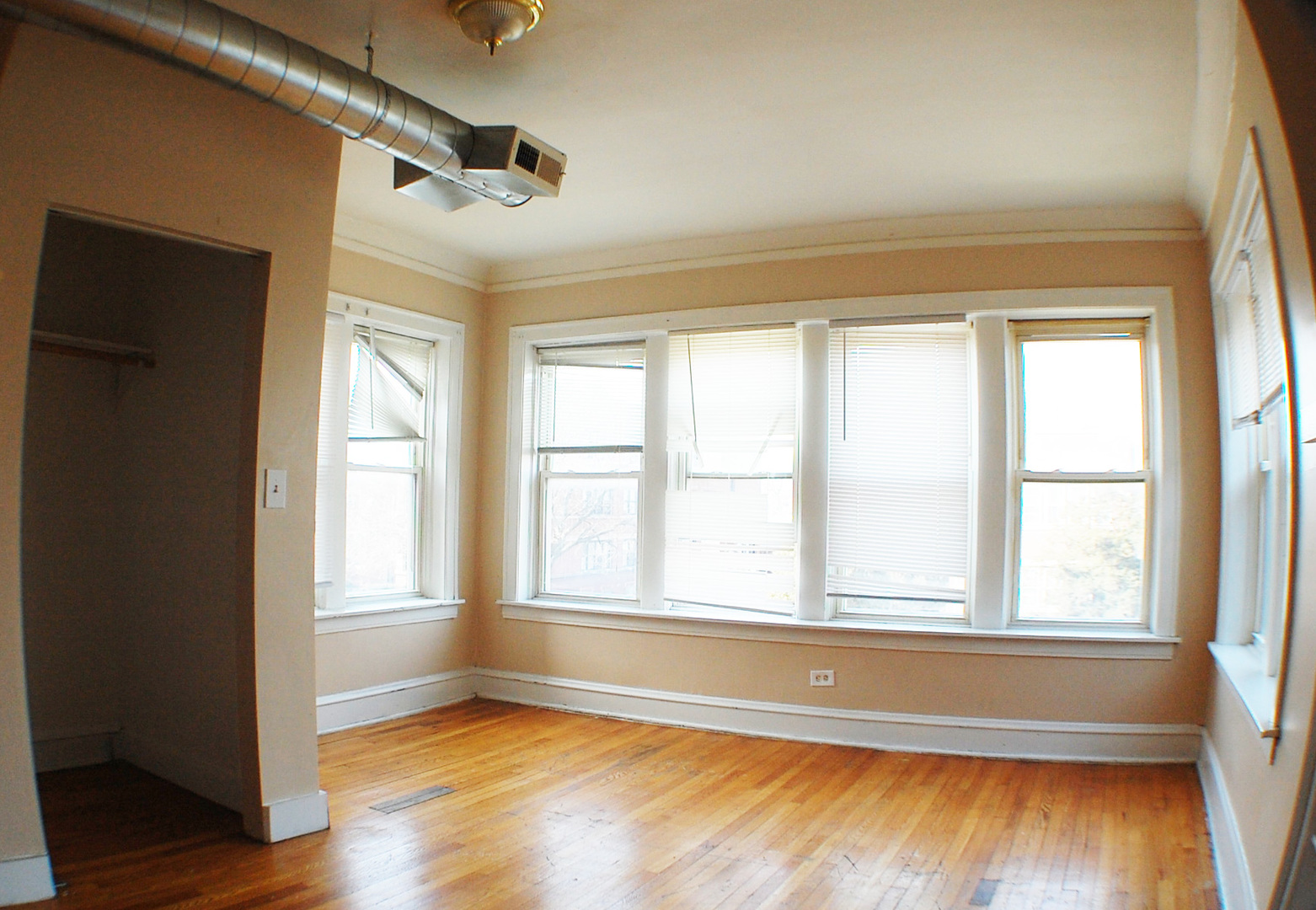 7757 South Paulina Street Chicago, IL 60620 - Photo 6 of 17 a view of an empty room with wooden floor and a window