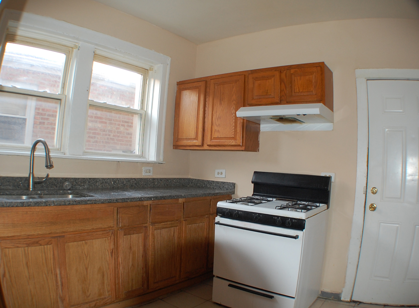 7757 South Paulina Street Chicago, IL 60620 - Photo 8 of 17 a kitchen with stainless steel appliances granite countertop a sink stove and refrigerator