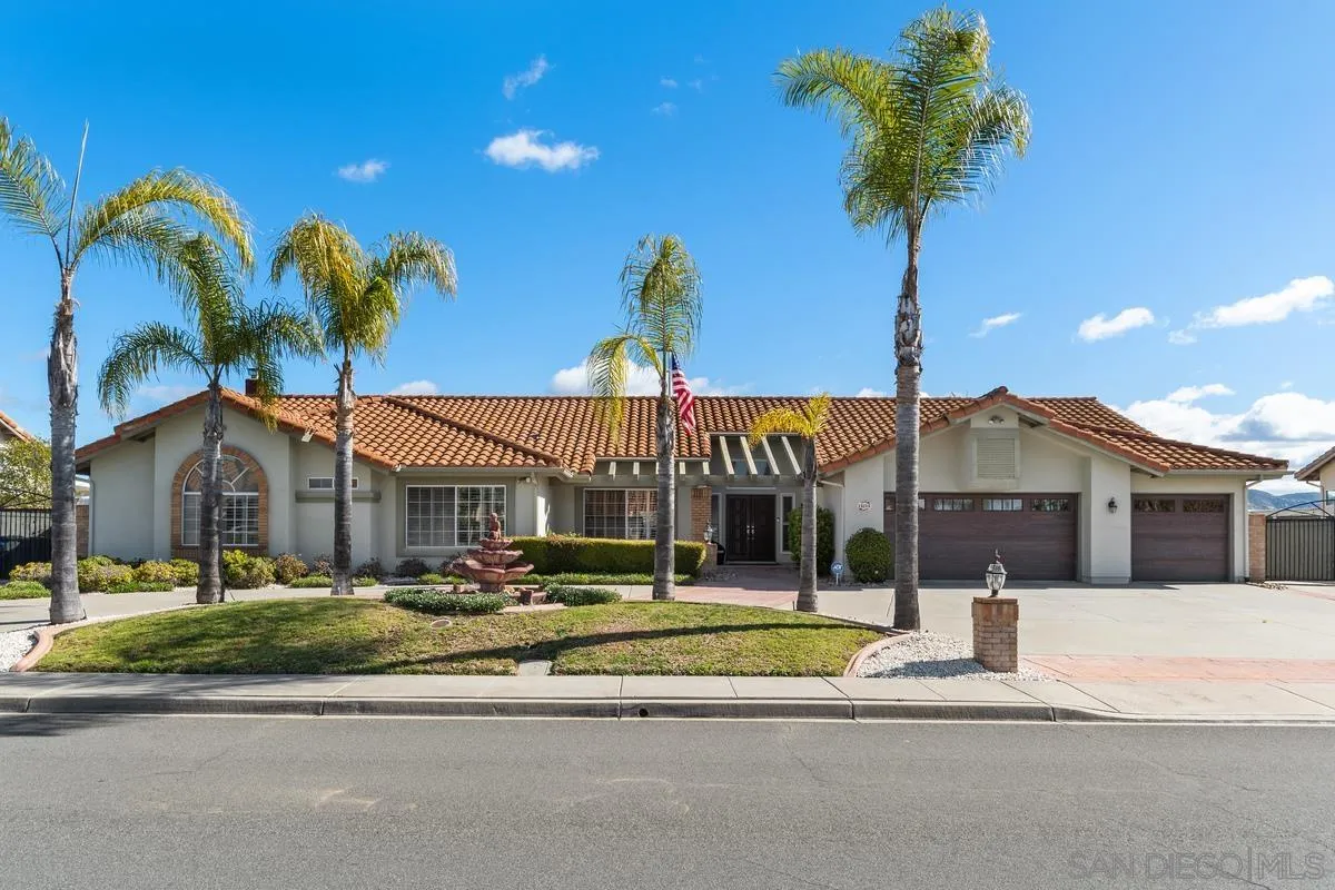 a front view of a house with a garden and a yard