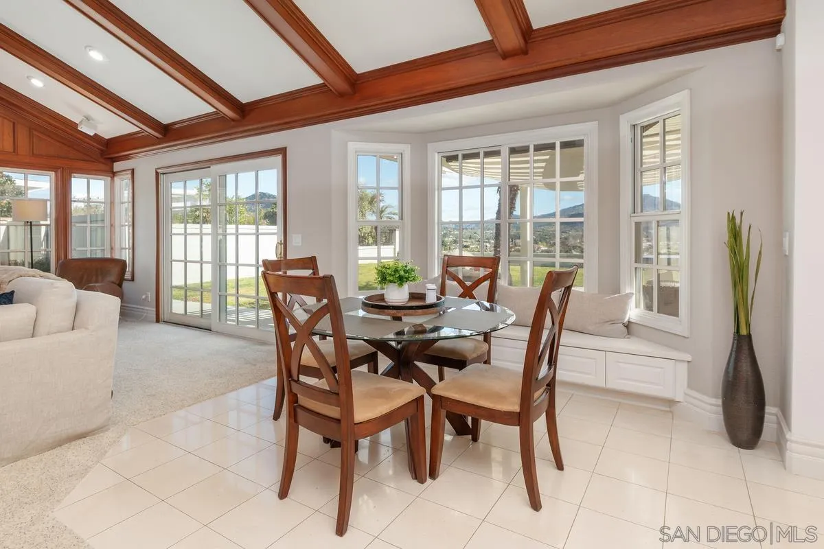 14134 Palisades Drive Poway, CA 92064 - Photo 12 of 32 a view of a dining room with furniture large windows and wooden floor