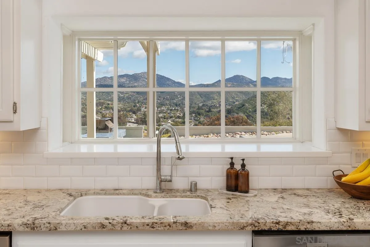 14134 Palisades Drive Poway, CA 92064 - Photo 16 of 32 a kitchen with granite countertop a sink and a window