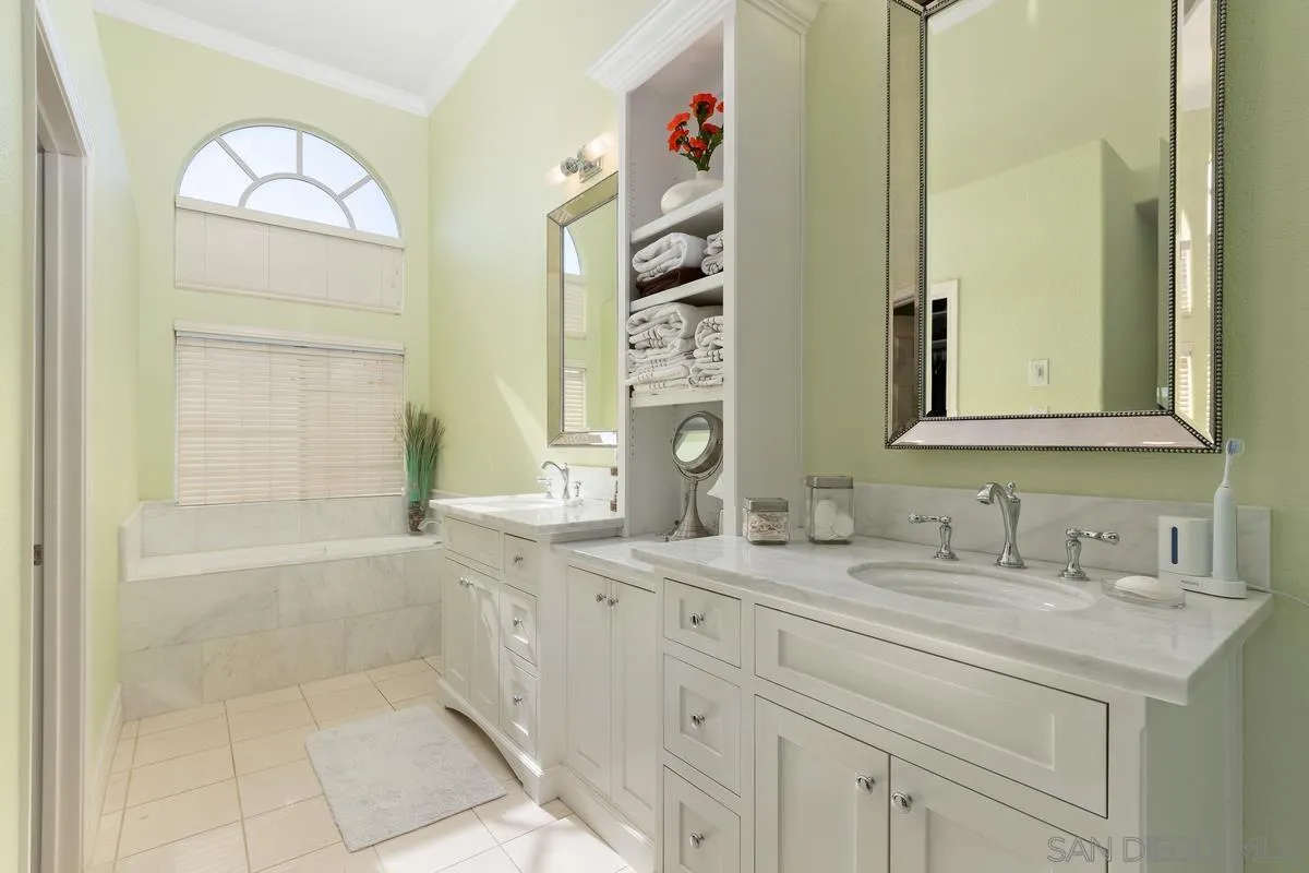 14134 Palisades Drive Poway, CA 92064 - Photo 21 of 32 a bathroom with a double vanity sink mirror and a bathtub