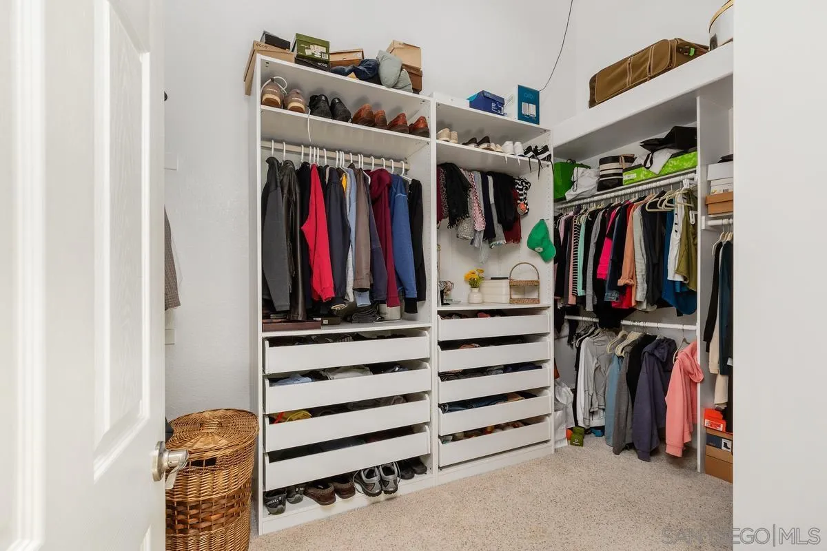 14134 Palisades Drive Poway, CA 92064 - Photo 22 of 32 a view of walk in closet with clothes and shoes