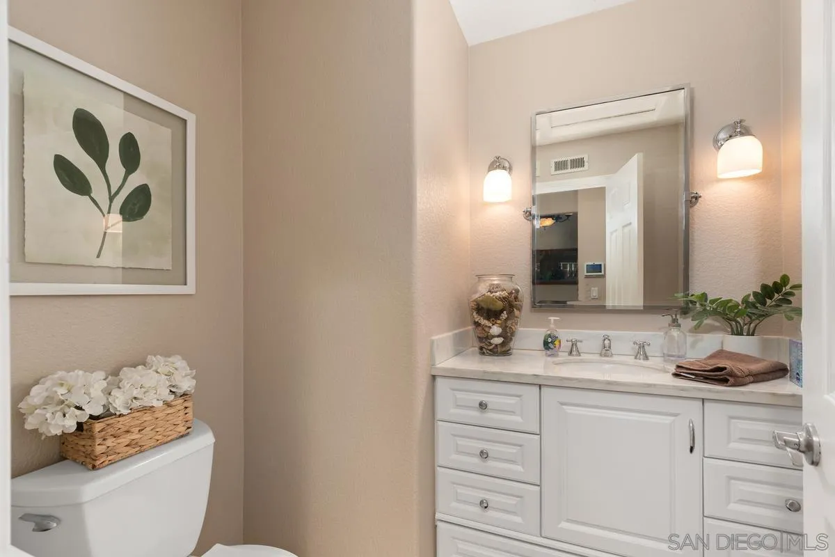 14134 Palisades Drive Poway, CA 92064 - Photo 27 of 32 a bathroom with a double vanity sink and a mirror