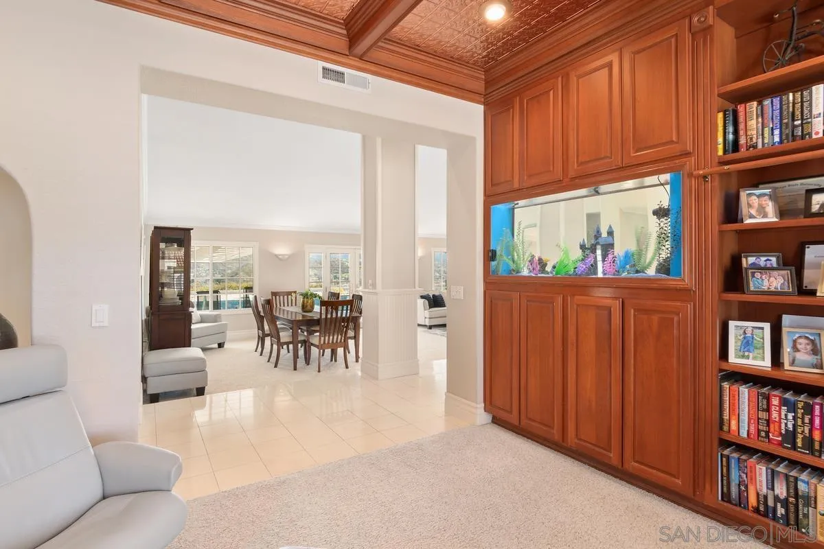 14134 Palisades Drive Poway, CA 92064 - Photo 9 of 32 a living room with lots of furniture and a book shelf