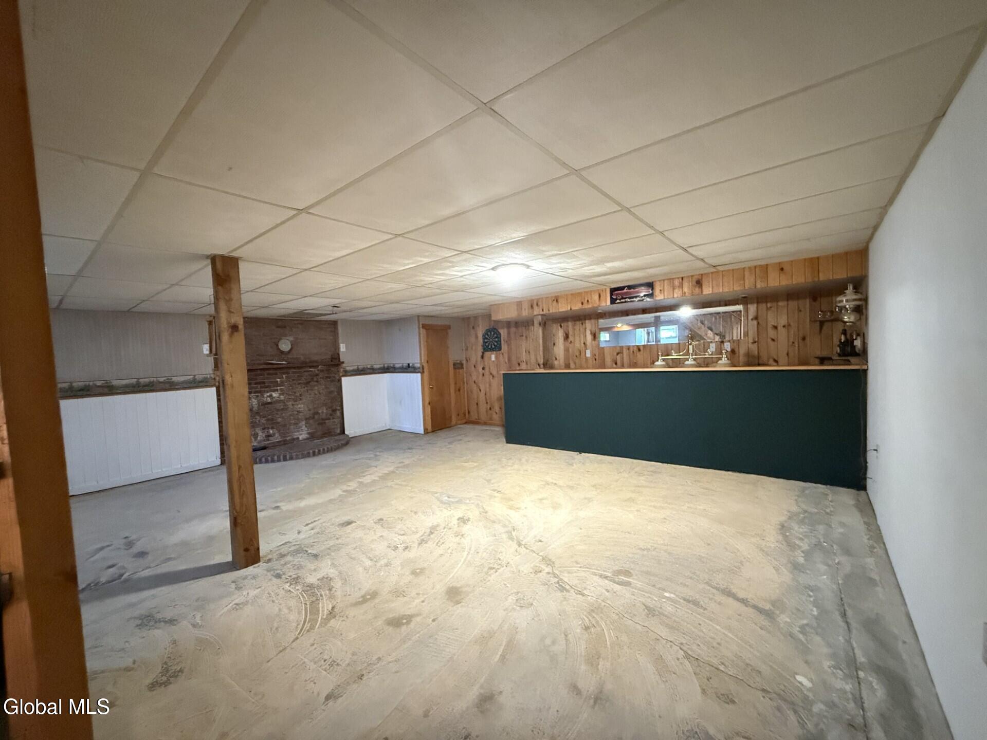 695 Dean Road Hudson Falls, NY 12839 - Photo 33 of 35 basement with bar and wood stove hearth