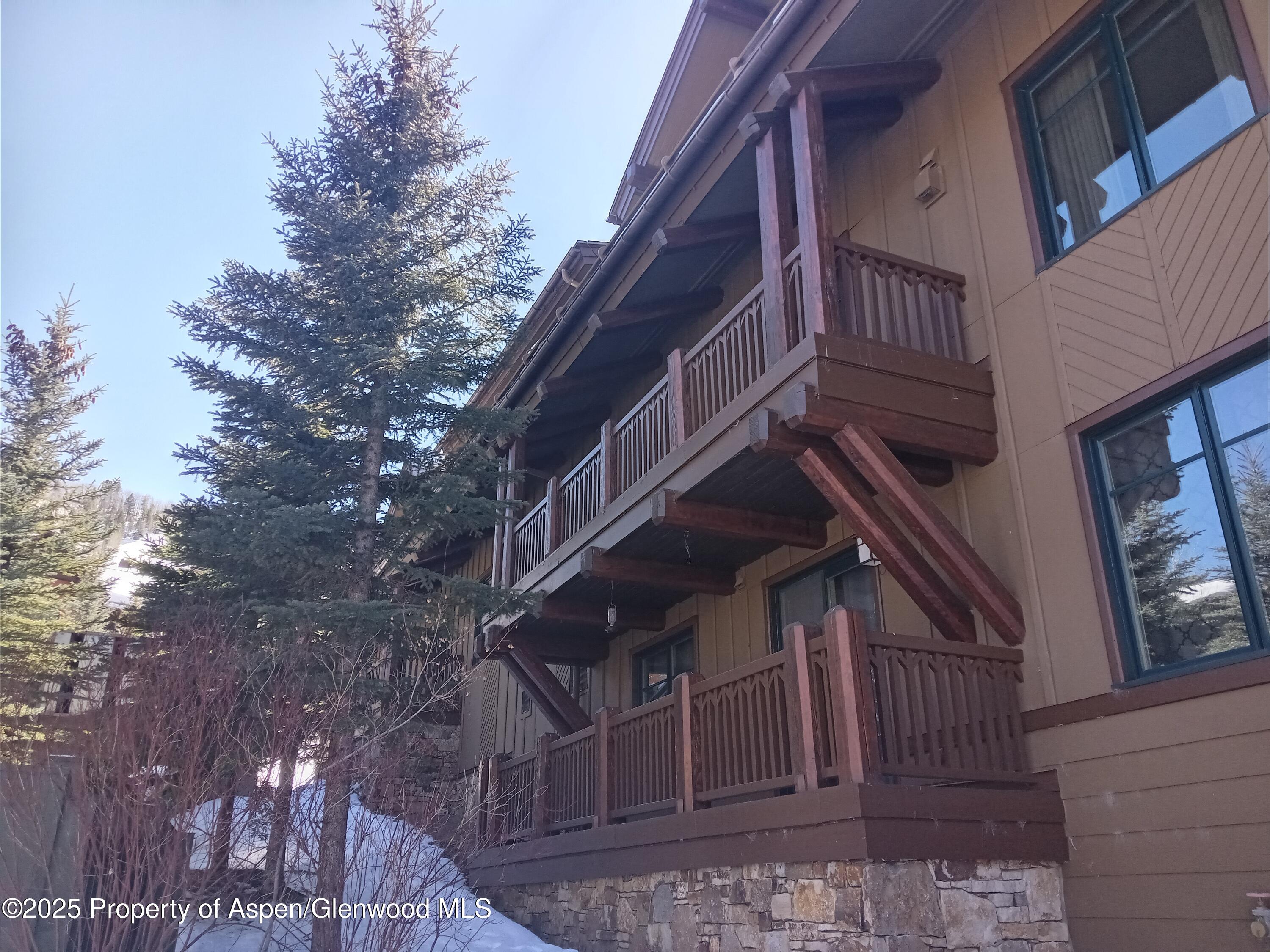197 Prospector Road, Unit 2310 SUMMER INTEREST #12 Aspen, CO 81611 - Photo 31 of 31 a view of buildings with gardens