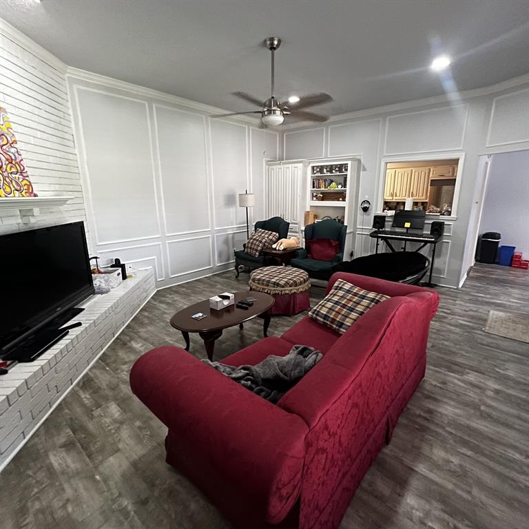 2029 Springwood Place, Unit A Carrollton, TX 75006 - Photo 3 of 9 a living room with furniture a flat screen tv and kitchen view