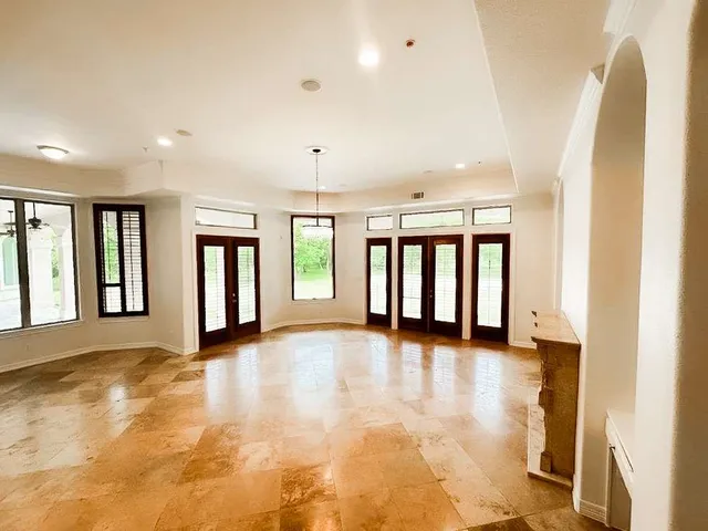 a view of an empty room with window and fireplace
