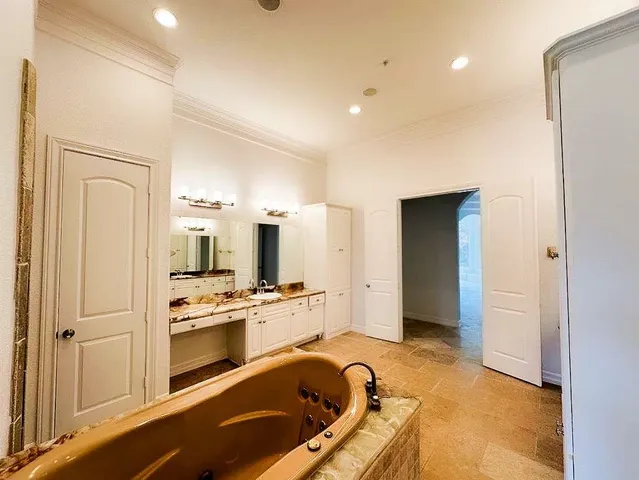 a room with stainless steel appliances kitchen island granite countertop a refrigerator and a stove