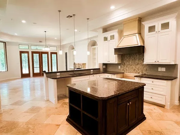 a kitchen with stainless steel appliances granite countertop a sink stove and a granite counter tops