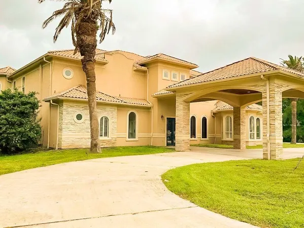 a view of a white house with a swimming pool