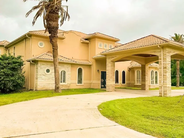 a view of a white house with a swimming pool