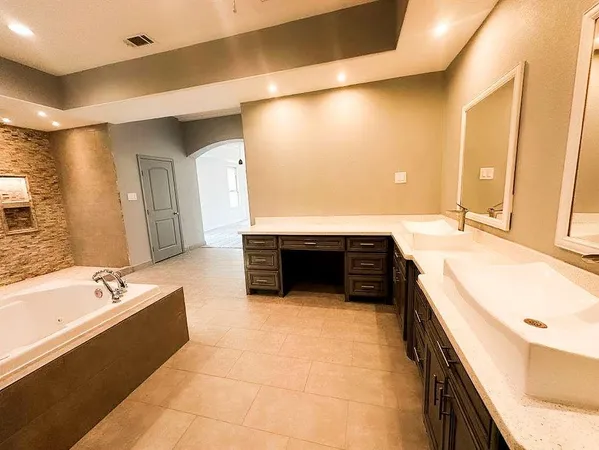 a bathroom with a tub and shower