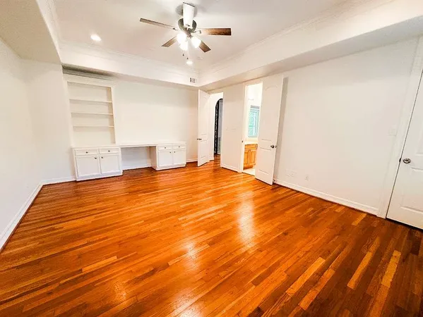 a view of an empty room with wooden floor