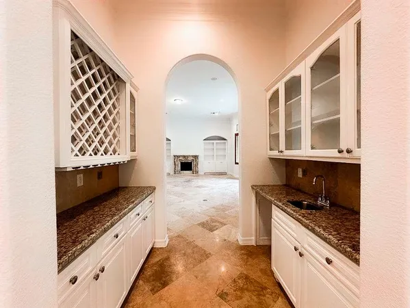 a large kitchen with granite countertop a stove and a sink