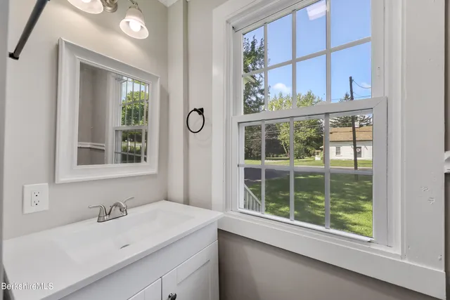 a bathroom with a sink and a window