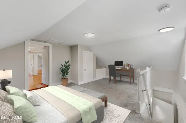 a bedroom with a bed and a potted plant