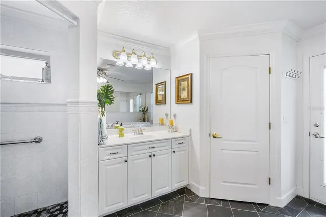a en suite bathroom with a sink a mirror and a shower