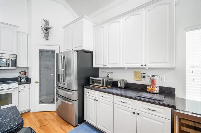 a kitchen with stainless steel appliances a refrigerator sink and cabinets